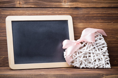 Menu blackboard and white heart, wooden background.の写真素材