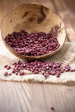 Chinese beans in wooden bowl on wooden surface. Eco product.の写真素材