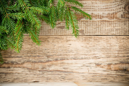 Spruce branch on a wooden background. Christmas card.の写真素材