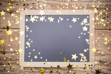 Spruce branches with decorative stars on wooden background.の写真素材