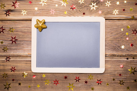 Confetti stars on wooden with blackboard.の写真素材