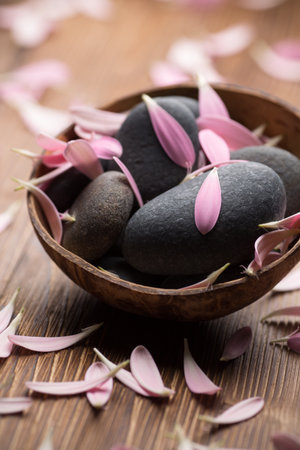 Spa stones with flower petals. Relaxing massage.の写真素材