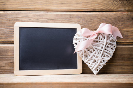 Menu blackboard and white heart, wooden background.の写真素材