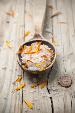 Homeopathic medicine; flower dry petals and spoon; wooden surface.の写真素材