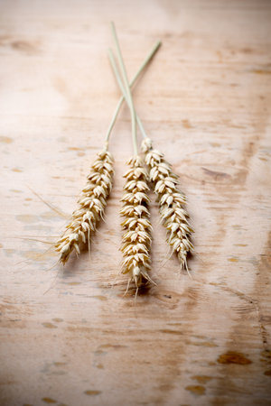 Wheat bunch with a menu board, wooden background.の写真素材