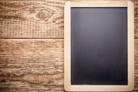 Menu blackboard and wooden background.の写真素材