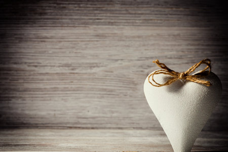 Heart on a wooden background. Vintage style.の写真素材