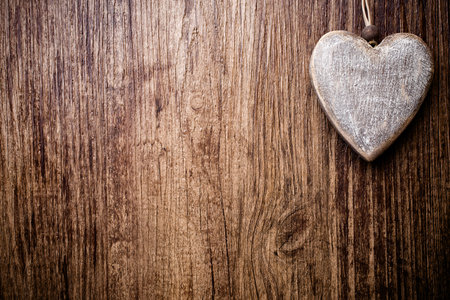 Heart on a wooden background. Vintage style.の写真素材