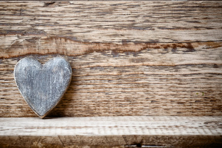 Heart on a wooden background. Vintage style.の写真素材