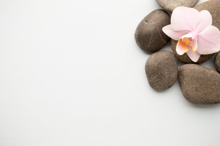 Spa stones on wooden background with orchids.の写真素材