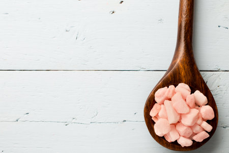 Sea salt wooden spoon on the pink orchid.の写真素材