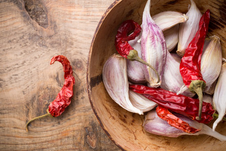Garlic with red chili pepper on wooden background.の写真素材