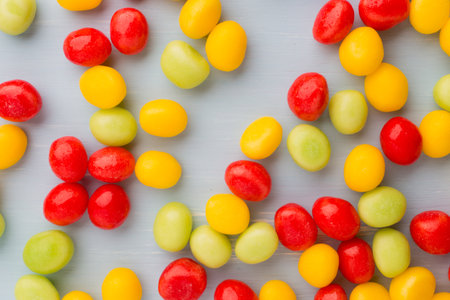 Small round candy-colored pastels on pastel background.の写真素材