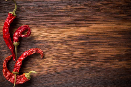 Red chili peppers on a wooden background. The menu background.の写真素材