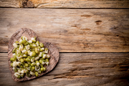 Sprouts to the heart of the bowl and on a wooden table.の写真素材