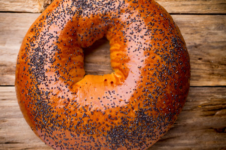 Freshly baked bread with poppy seeds on a wooden background.の写真素材