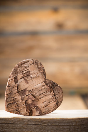 Bark heart on wooden background. Studio photography.の写真素材