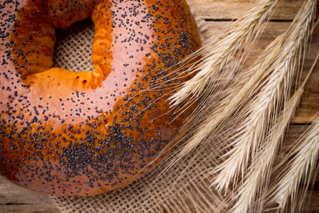 Freshly baked bread with poppy seeds on a wooden background.の写真素材