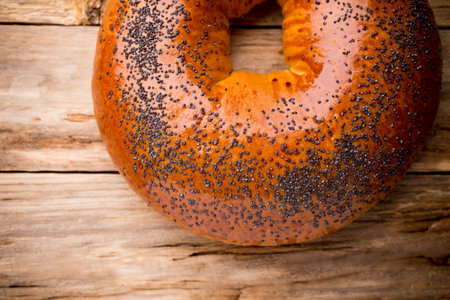 Freshly baked bread with poppy seeds on a wooden background.の写真素材