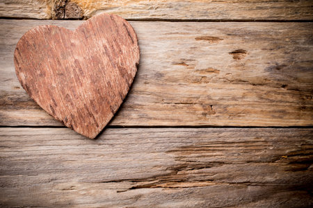 Heart on a wooden shelf. Wooden wall, studio photography.の写真素材