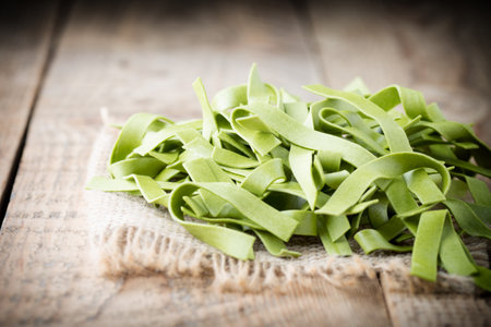 Spinach pasta on the wooden background, photo studio.の写真素材