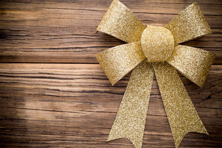 Christmas bow golden color. On colored paper .の写真素材
