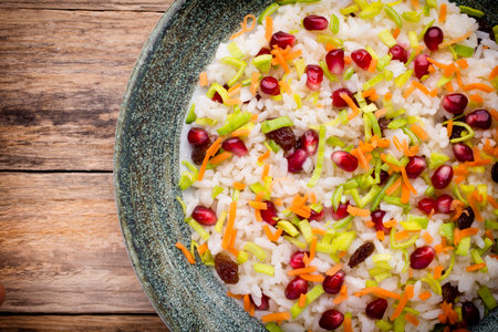 Rice dish. Pomegranate with raisins. Vegetarian food.の写真素材