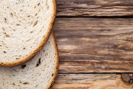Slices of bread on a wooden background.の写真素材