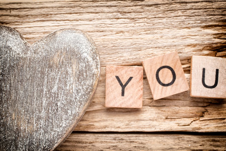 Wood heart on old wooden background の写真素材