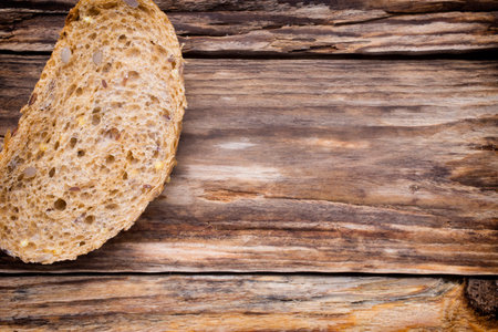 Slices of bread on a wooden background.