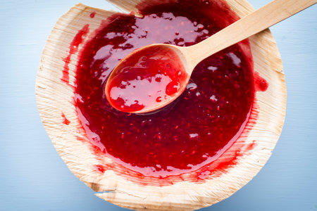 Raspberry jam spoon. Studio photography.