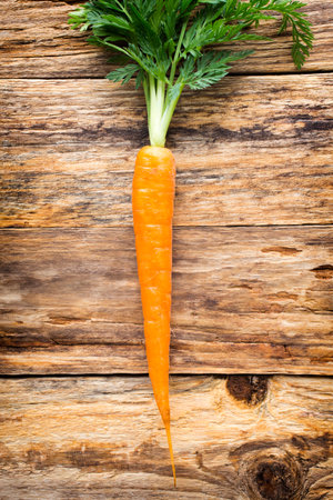 Fresh carrots on a wooden background.の写真素材