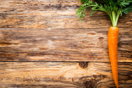 Fresh carrots on a wooden background.の写真素材