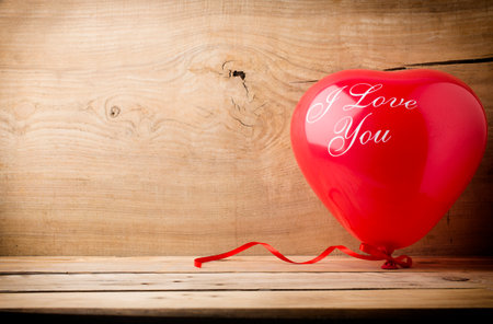 Red heart-shaped balloon with the words I love you.の写真素材