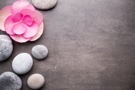 Close up view of spa stones and flower on grey background.の写真素材