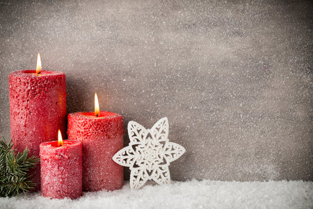 Three red candles on gray background, Christmas decoration. Advent mood.の写真素材