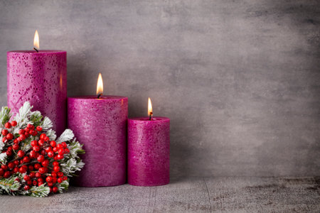Three purple candles on gray background, Christmas decoration. Advent mood.の写真素材