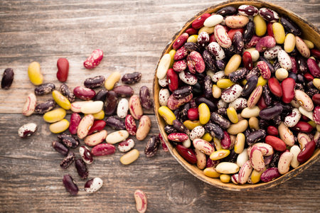 Beans  on the bowl and wooden background.