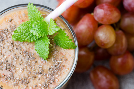 Grape smoothie, on the grey  background.の写真素材