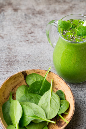 Spinach smoothie, on the grey  background.の写真素材