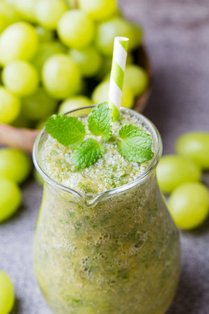 Grape smoothie, on the grey  background.の写真素材