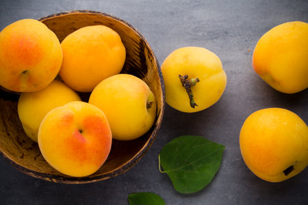 Apricot with leaves on wooden background.の写真素材