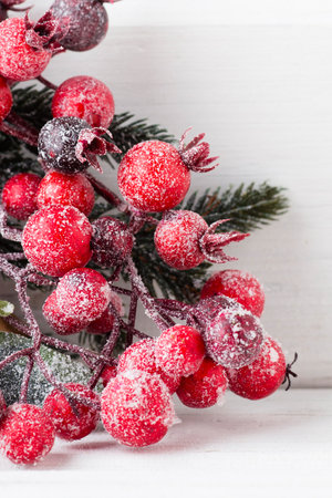 Christmas wreath from red berries, a fur-tree and conesの写真素材
