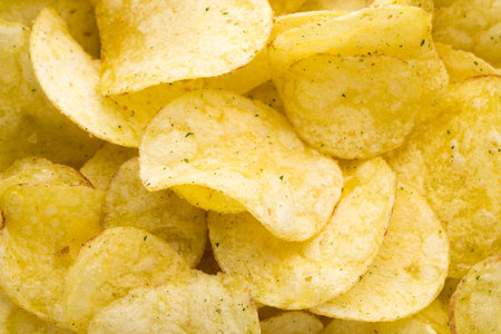 Potato chips on top view background.