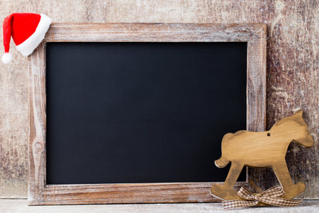 Christmas chalkboard and decoration over wooden background.の写真素材
