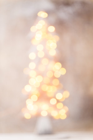 Defocused christmas tree silhouette with blurred lights.の写真素材