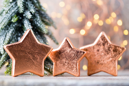 Bronze christmas star decoration. Holiday decorations bronze on bokeh background.の写真素材