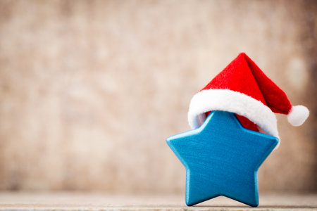 Stars decoration. Christmas symbol with santa hat. Vintages background.の写真素材