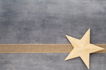 Christmas gold stars. Christmas pattern. Background on the gray color.の写真素材