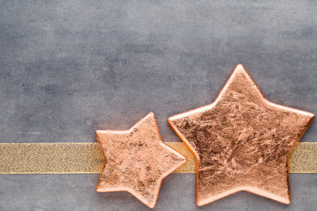 Christmas gold stars. Christmas pattern. Background on the gray color.の写真素材